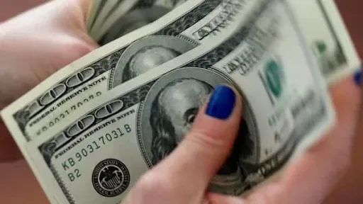 Counting money representing roofing savings